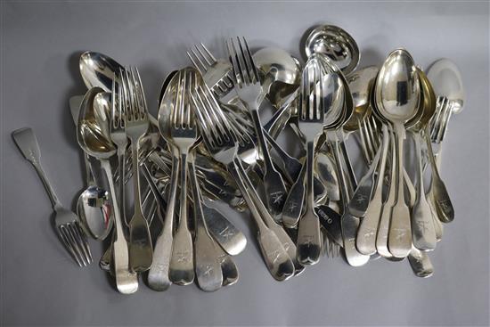 A harlequin part canteen of mainly 19th century Scottish silver fiddle pattern flatware with engraved crest, 77.5 oz.